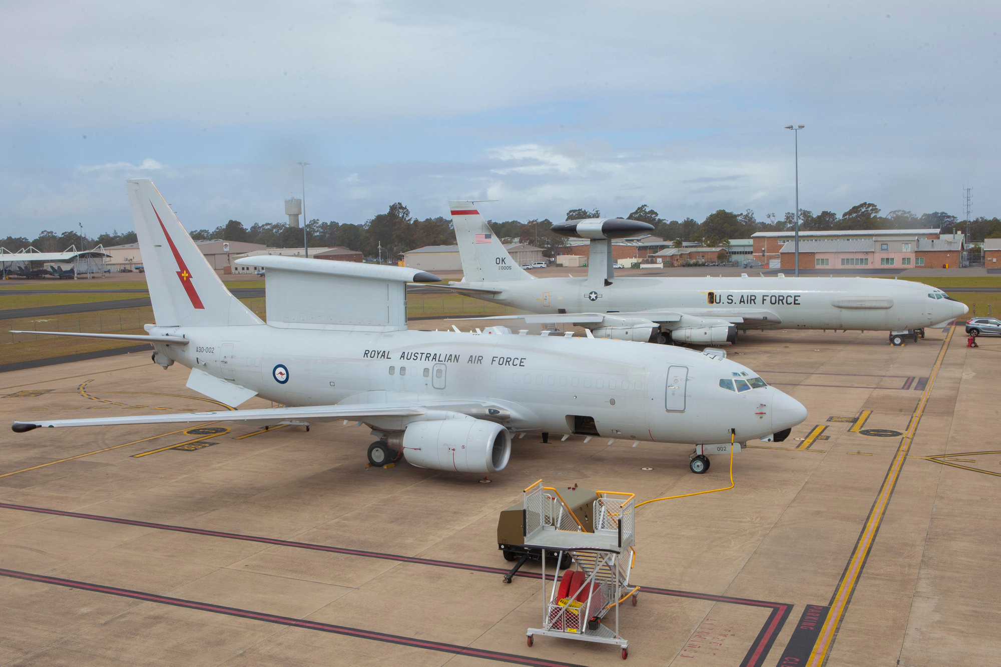 A RAAF E-7A Wedgetail and USAF E-3 Sentry sit side by side at RAAF Williamtown.