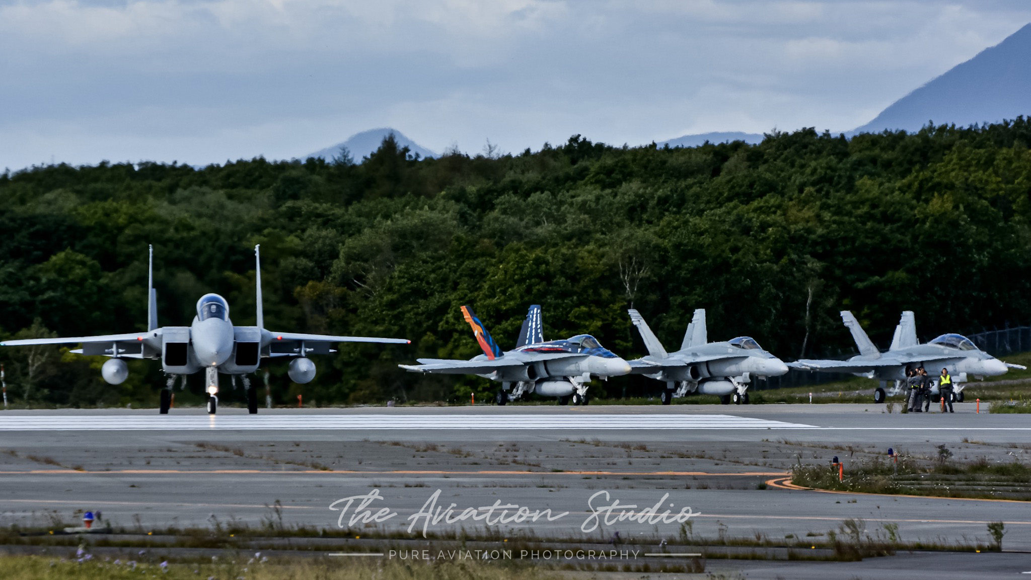 JASDF F-15DJ entering RWY36R at Chitose Air Base whilst three RAAF F/A-18A/B hold short